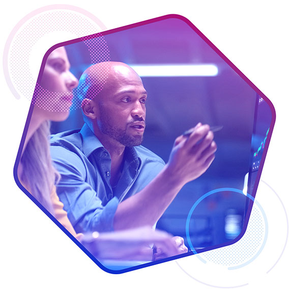 Man and woman looking at a screen with graphical data