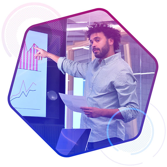 Man pointing at a graph on a large screen