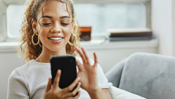 Lady smiling while looking at mobile phone