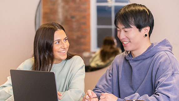 Man and woman smiling and talking