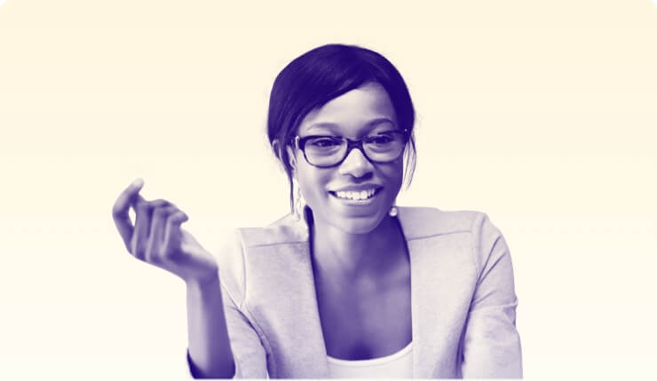 A woman in a suit wearing glasses