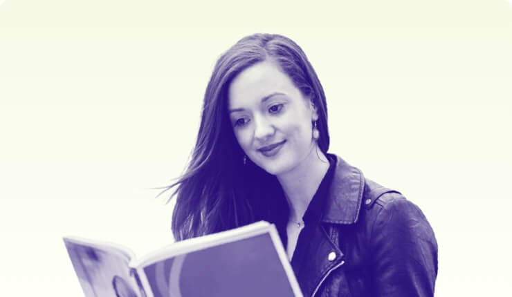 A woman reading a Kaplan Publishing book