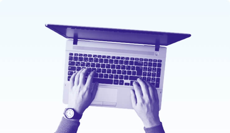 Two hands on a the keyboard of a laptop