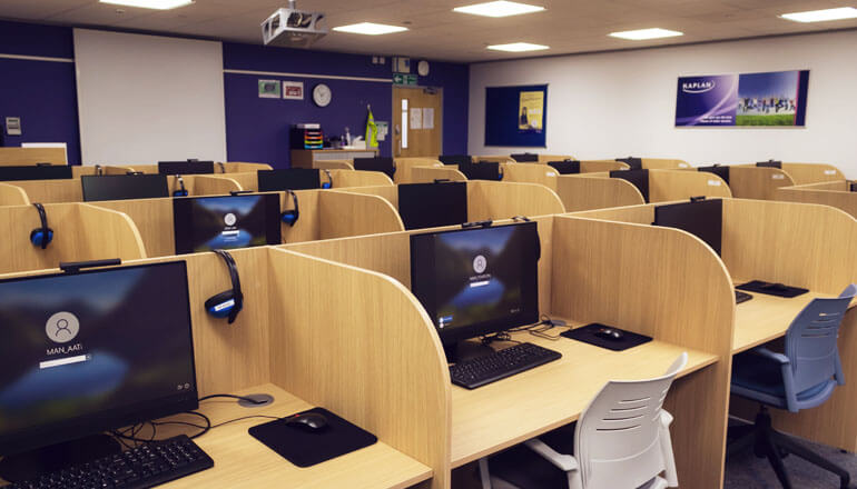 Exam room with desks, desk dividers and computers