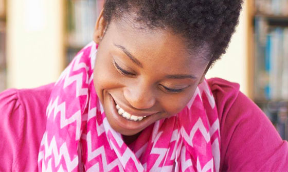 A woman wearing pink and smiling