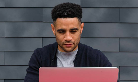 A man looking at a laptop