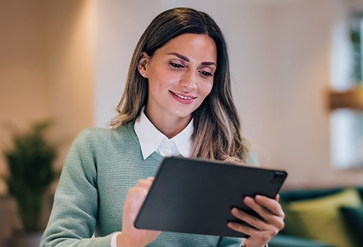 A woman looking at a tablet