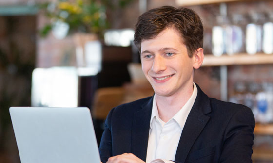 A man in purple shirt smiling