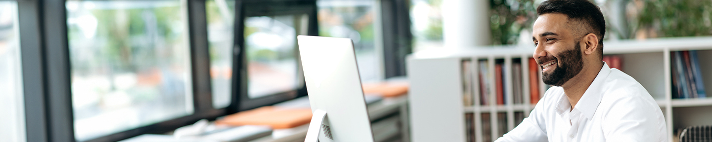 A man looking at a computer monitor.