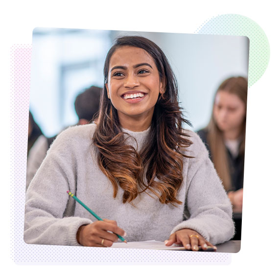 Woman smiling holding a pen