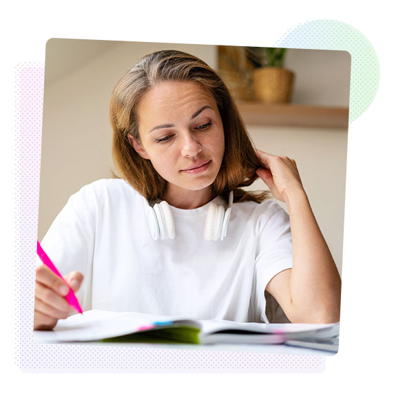 Woman smiling making notes in a book