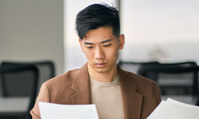 Man looking at sheets of paper